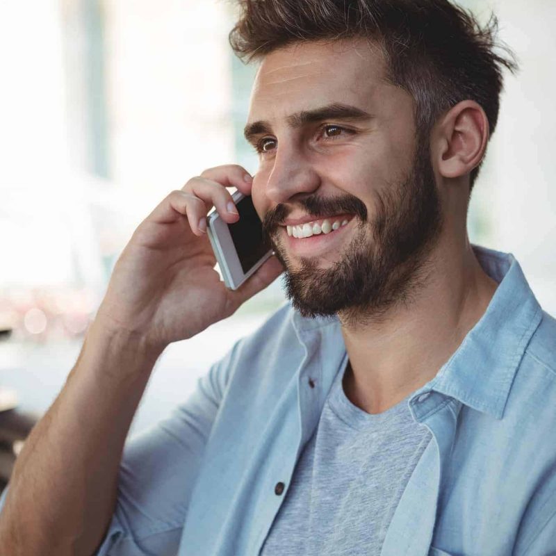 executive-talking-on-mobile-phone-in-park.jpg